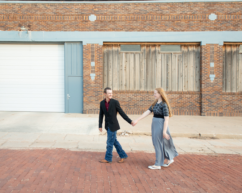 Couple walking in front of rustic building