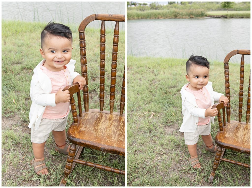 one year old standing by a rocking chair